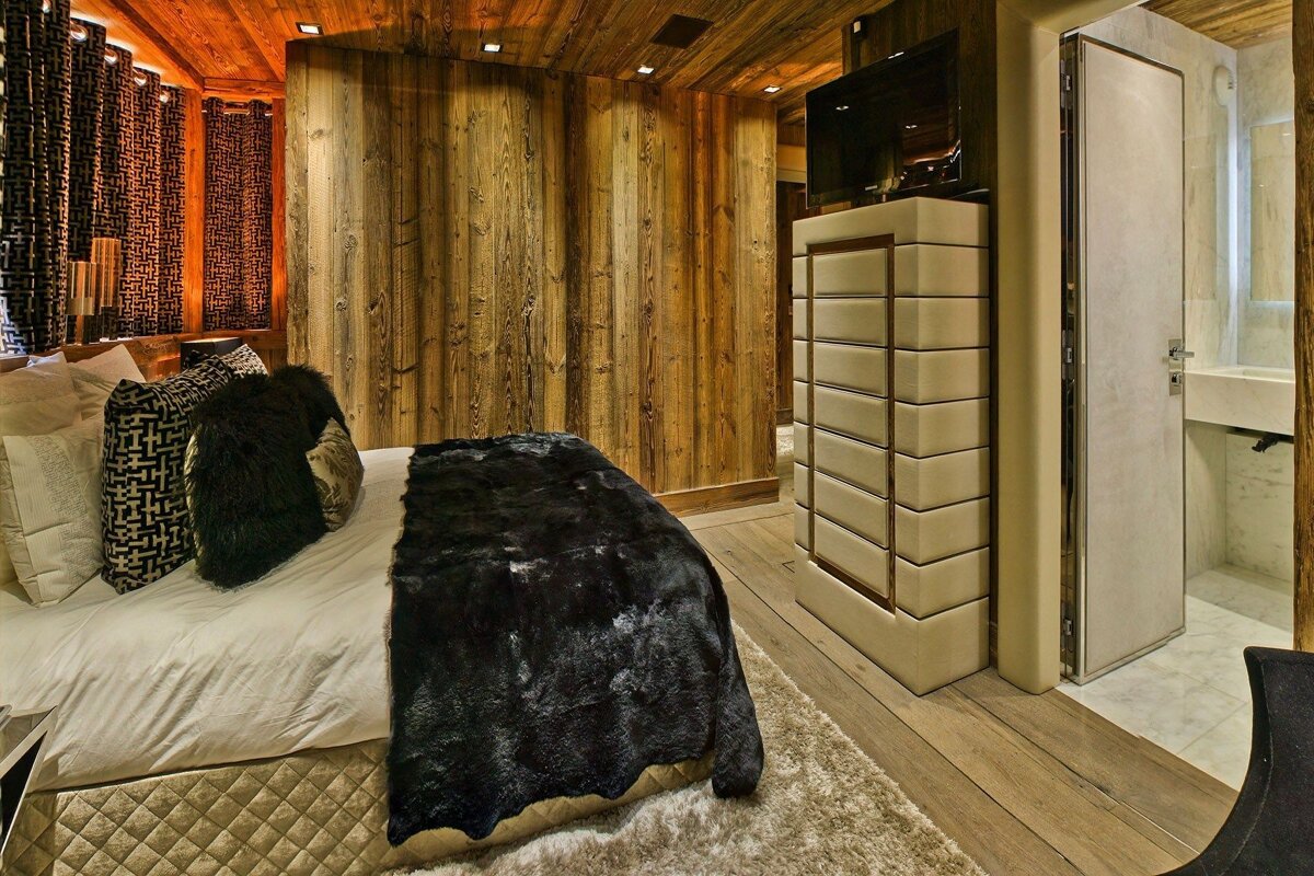 A bedroom with a fur blanket on the bed
