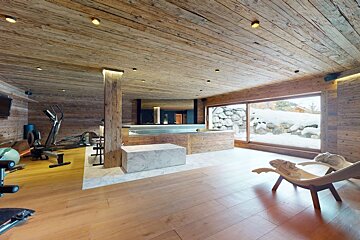 A gym with wooden walls and a large window
