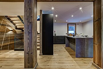 A kitchen with wooden floors and a black cabinet
