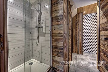 A bathroom with a shower and a sign that says mountain base