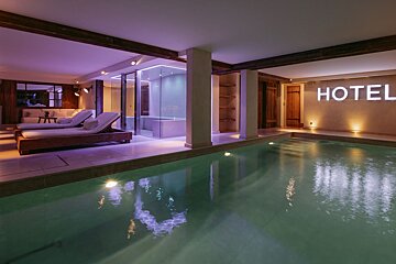 A swimming pool with the word hotel on the wall