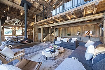 A living room with a fireplace hanging from the ceiling