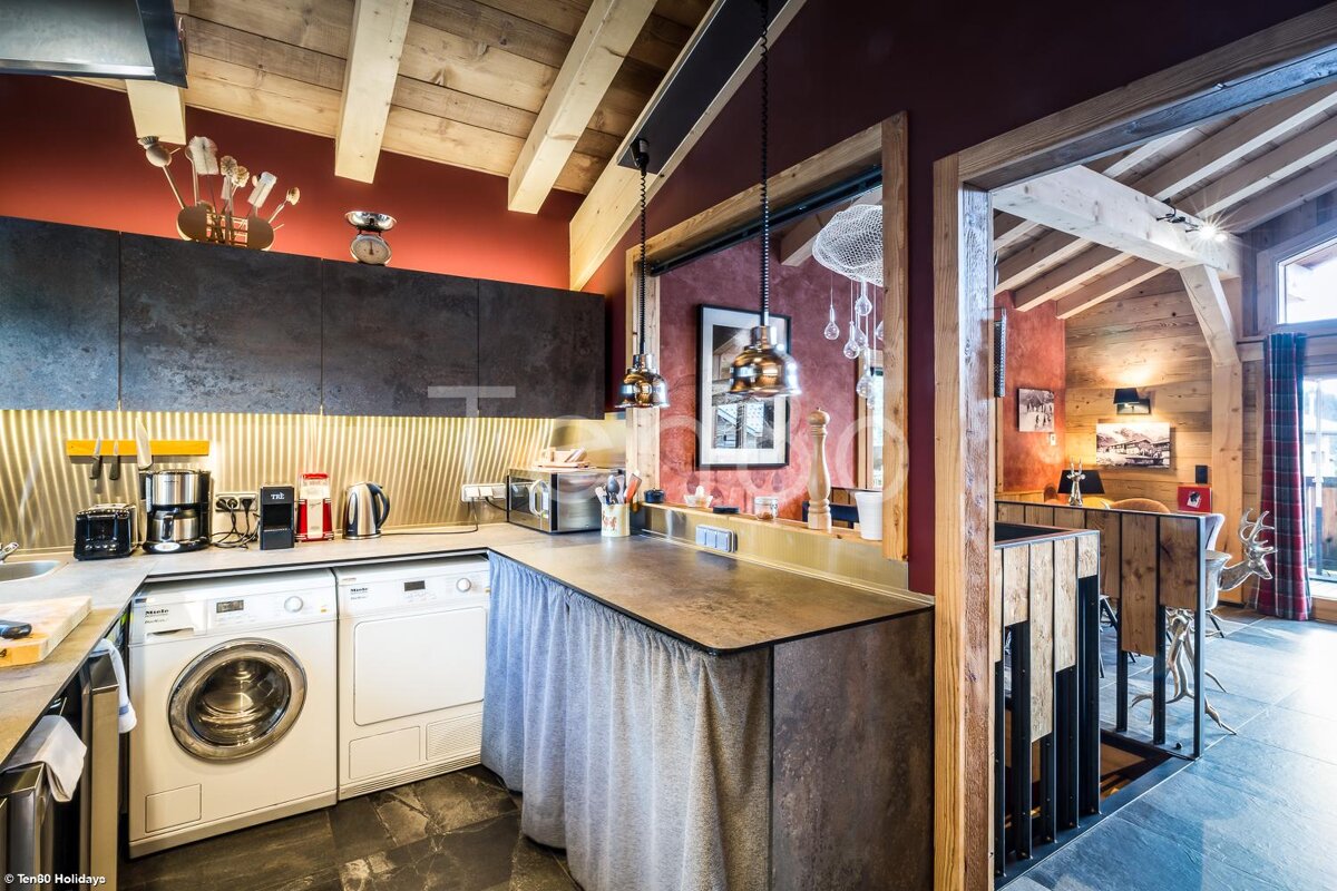 A kitchen with a washing machine and a dishwasher