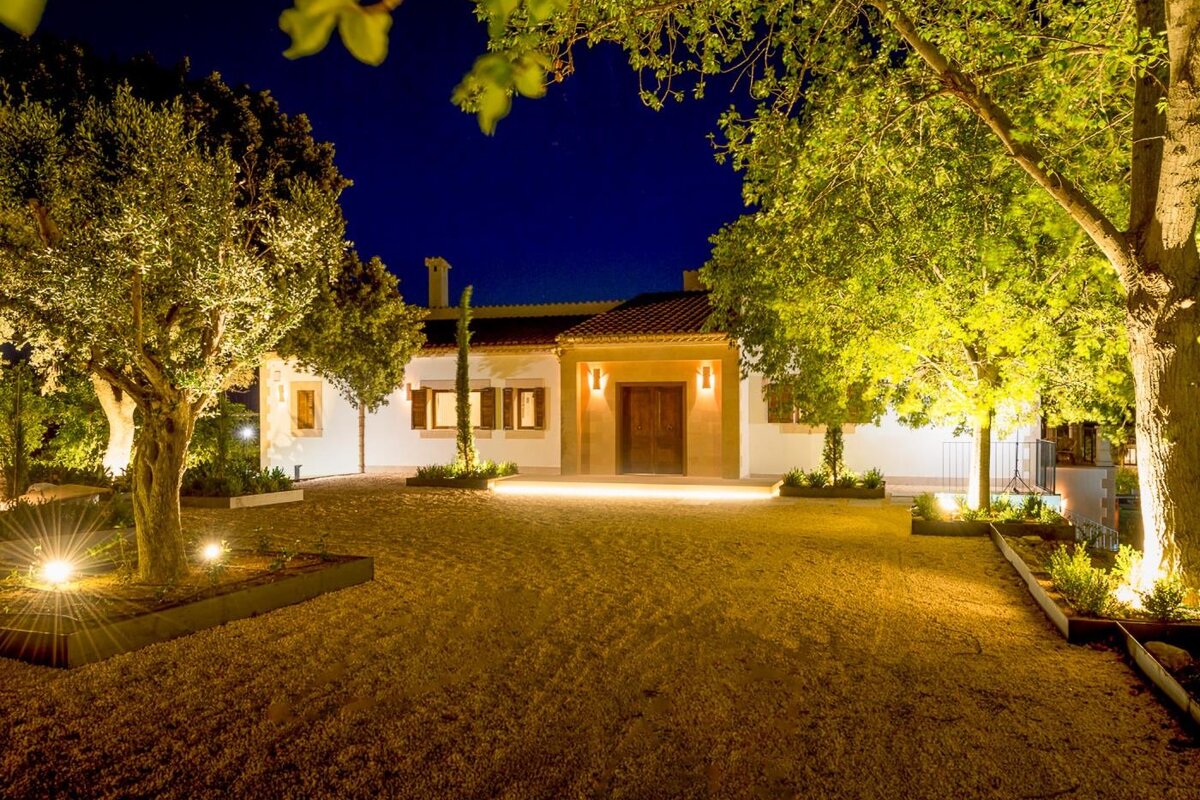 The front of a house is lit up at night