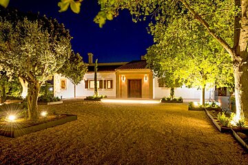 The front of a house is lit up at night
