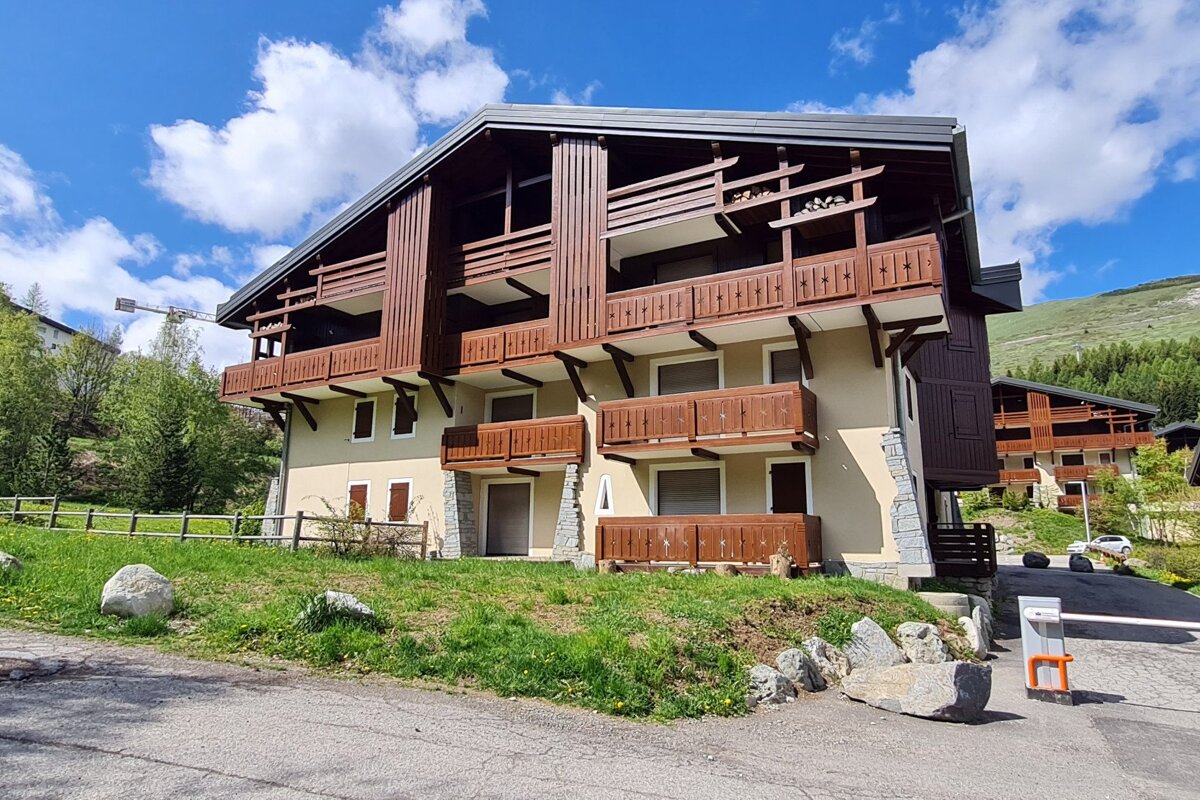 A building with a lot of balconies and a fence around it