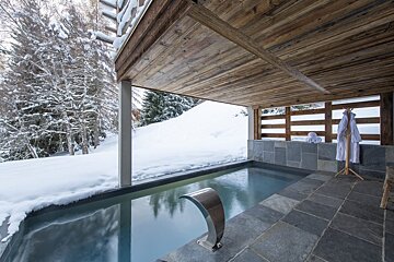 A swimming pool with a waterfall in the middle of it