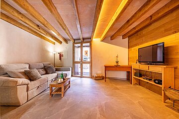 A living room with a couch and a flat screen tv
