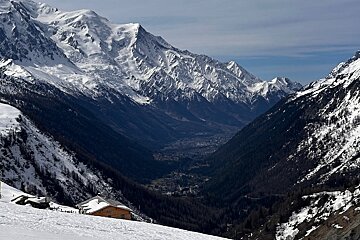 A snowy valley with mountains in the background