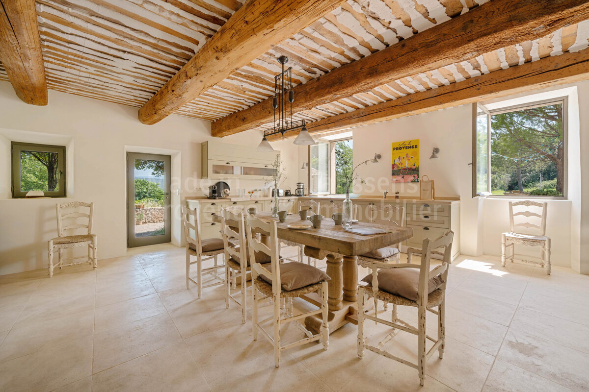 A room with a table and chairs and a sign that says 