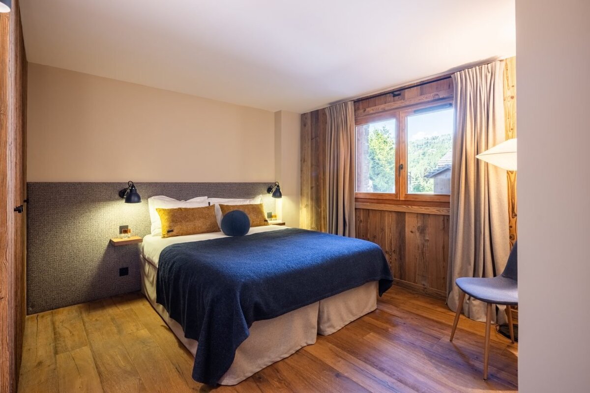 A bedroom with a large bed and a window