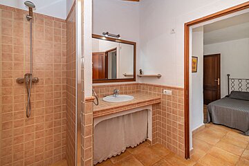 A bathroom with a sink and a walk in shower