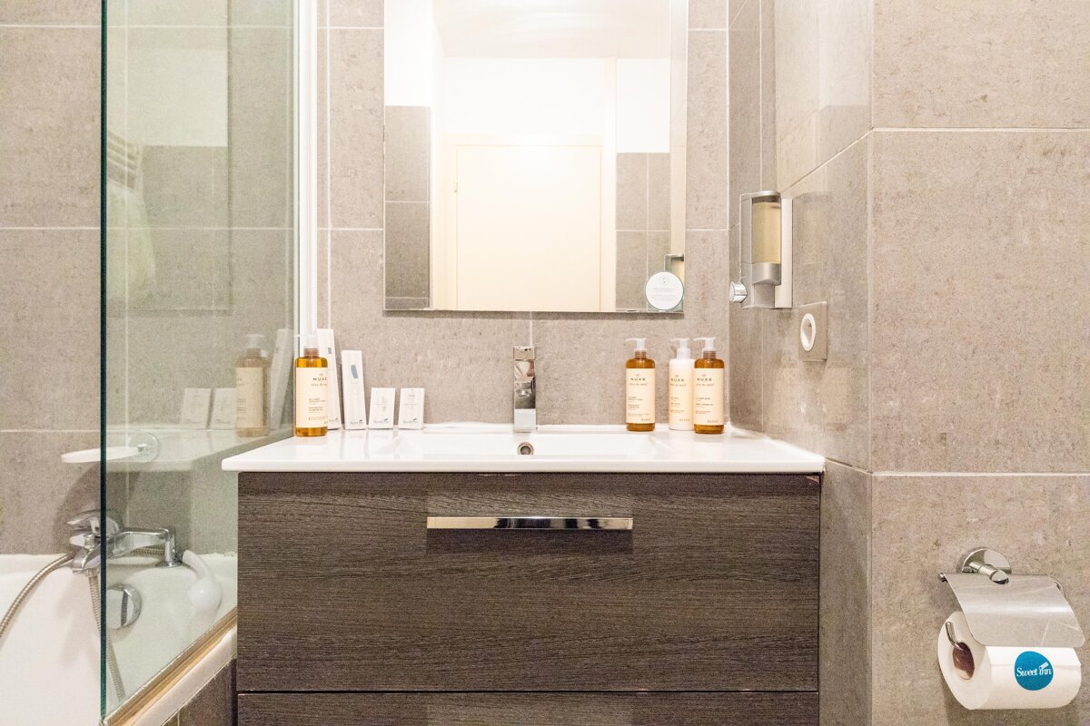 A bathroom with a sink and a toilet paper that says save