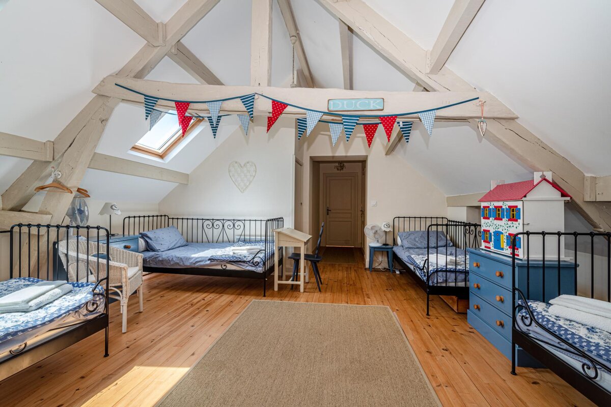 A bedroom with three beds and a sign that says luck