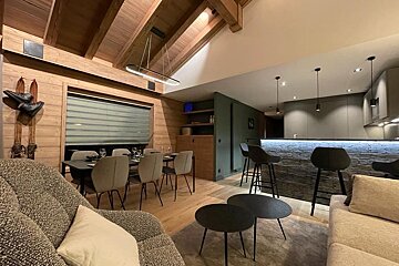 A living room with a couch a table and chairs