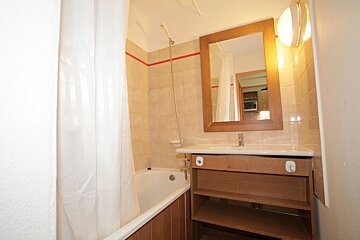 A bathroom with a bathtub and a sink