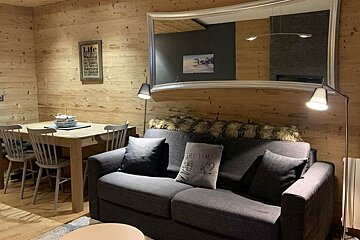 A living room with a sign on the wall that says life