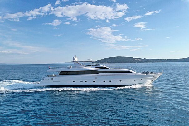 A large white yacht is floating in the ocean