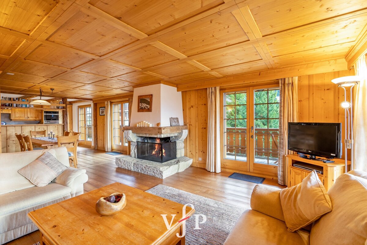 A living room with a fireplace and a flat screen tv