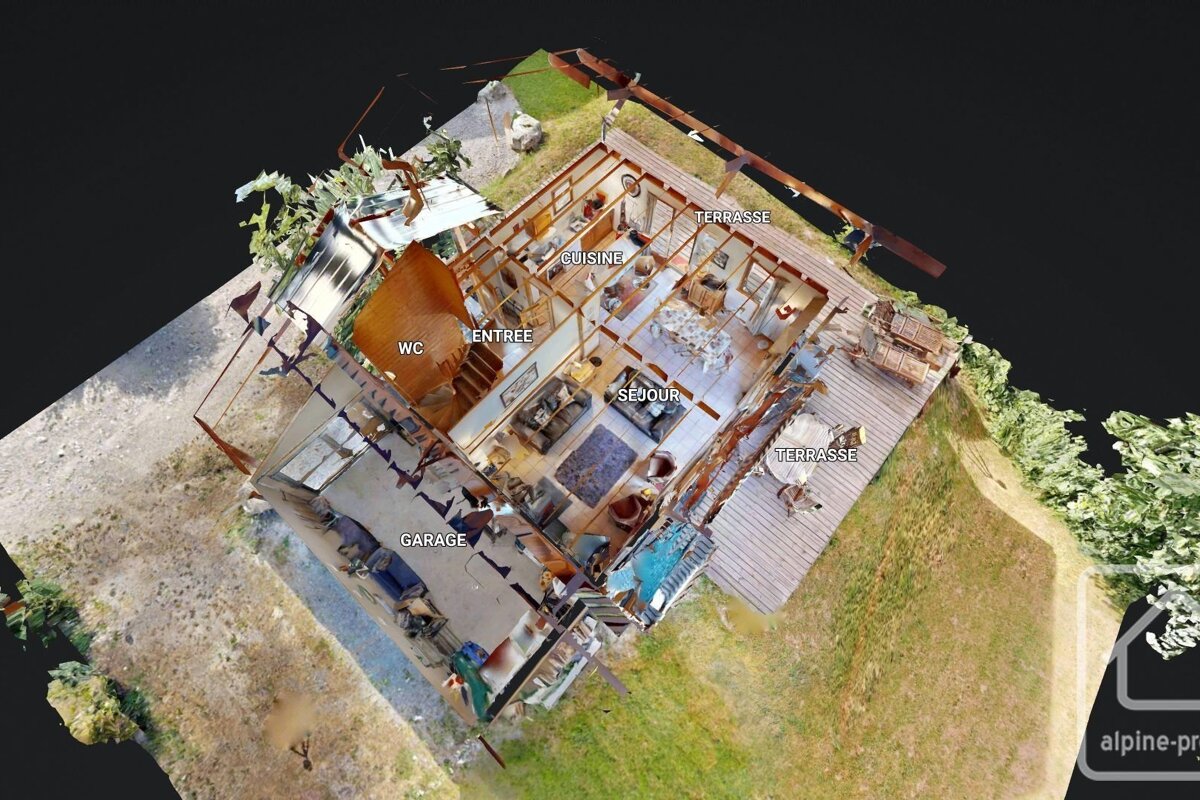 An aerial, 3D cutaway view of a house, showing labeled interior rooms (living, kitchen, garage, WC) and exterior terraces.
