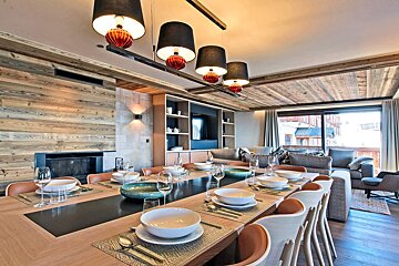 A dining room table with plates and bowls on it