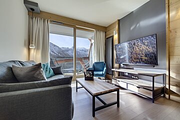 A living room with a large flat screen tv on the wall
