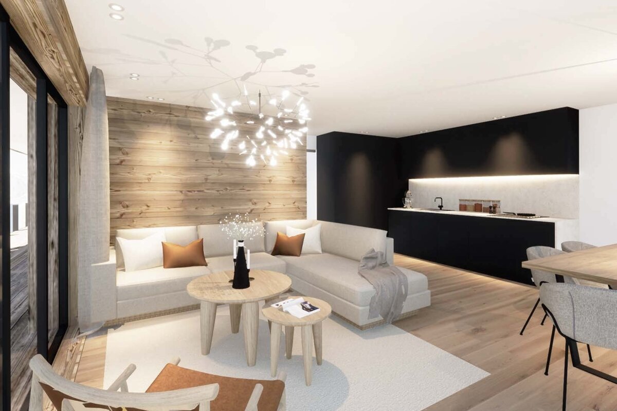 Cozy, modern open-plan space with a light wood accent wall, white sofa, sleek black kitchen, and a statement chandelier.