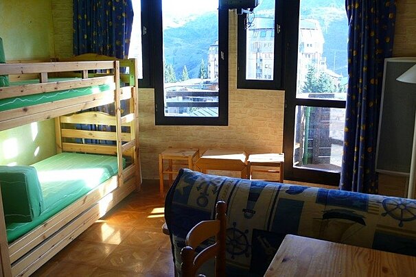 A room with bunk beds and a blue couch