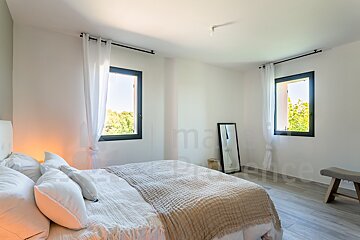 A bedroom with a bed and a mirror and the word marie on the wall