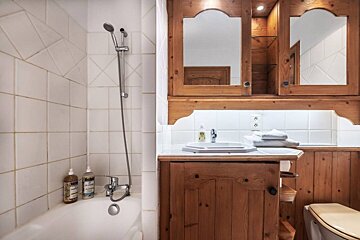 A bathroom with a sink a toilet and a shower