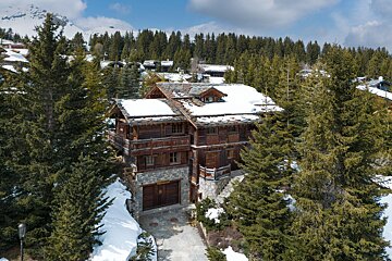A large house in the middle of a snowy forest