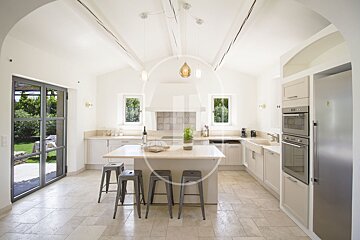 A kitchen with a large island and stools