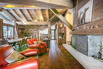 Snow covered buildings in a ski resort with mountains in the background