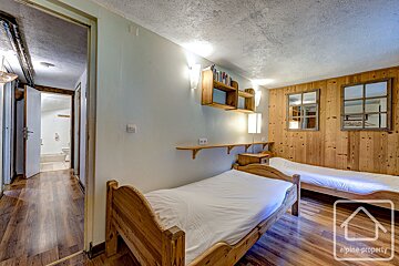 A bedroom with two beds and a sign that says alpine property