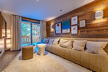 A living room with a wooden wall and a couch
