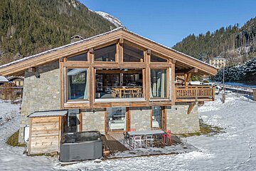 A large house with a hot tub in front of it