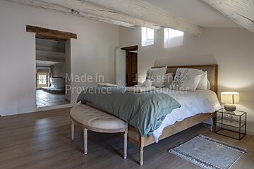 A bedroom with the words made in provence on the wall