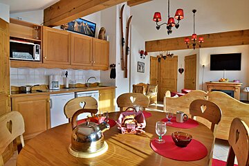 A dining room table with a basket of bread on it