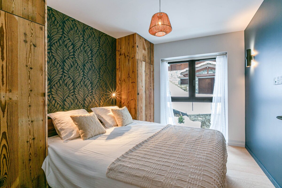 A bedroom with a large bed and a window