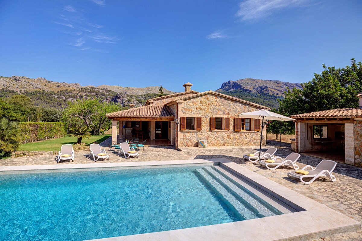 A house with a swimming pool in front of it