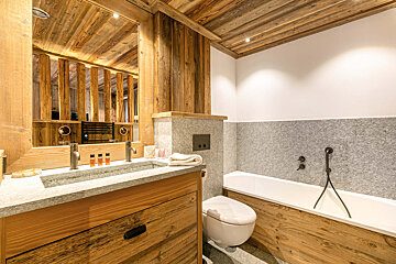 A kitchen with stainless steel appliances and wooden cabinets