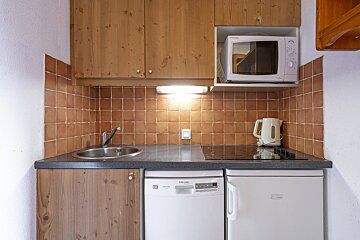 A small kitchen with a dishwasher and a microwave