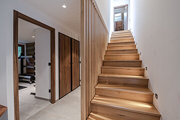 A wooden staircase leading up to the second floor of a house