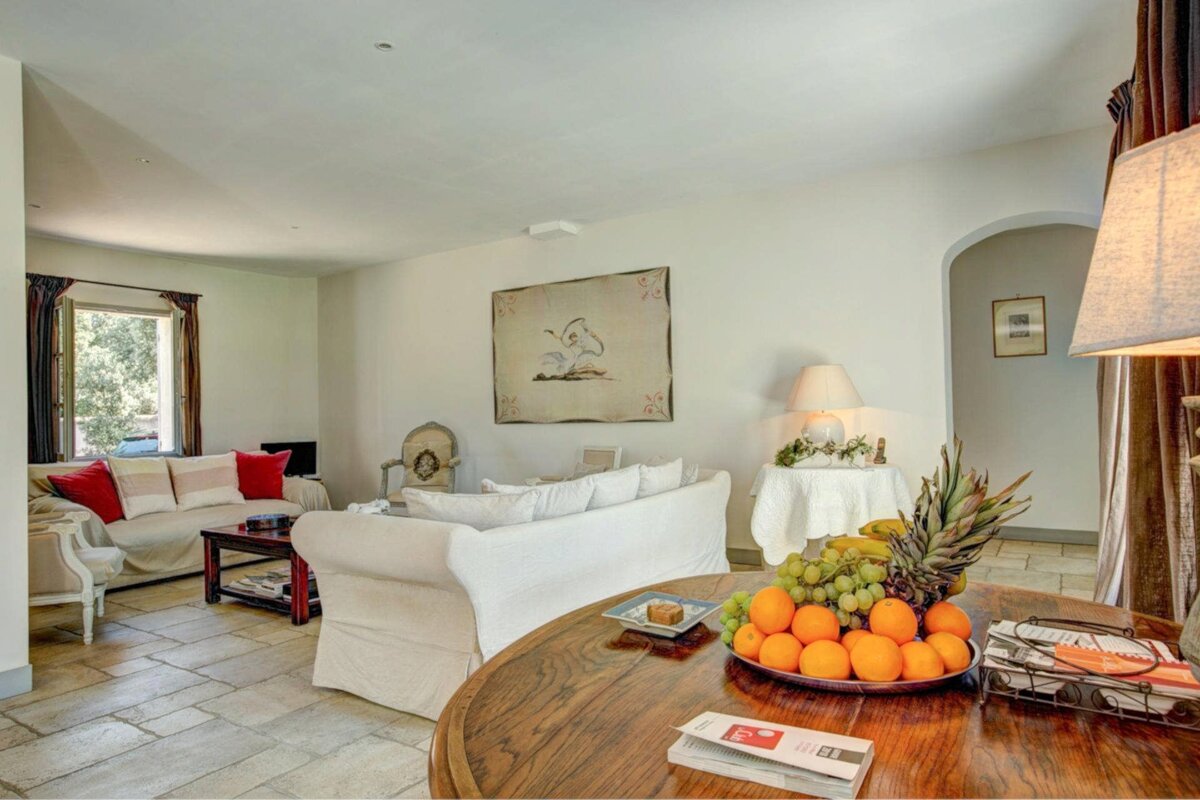 A living room with a couch and a table with fruit on it