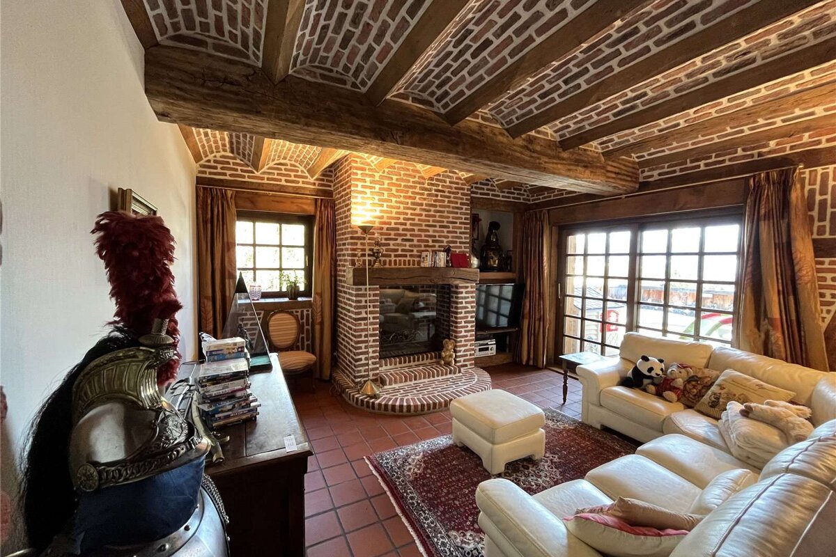 A living room with a brick fireplace and a couch