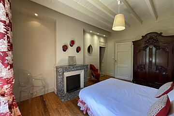 A bedroom with a fireplace and a bed