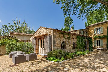 A stone building with a few chairs in front of it