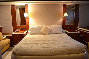 A bedroom with a large bed and two nightstands