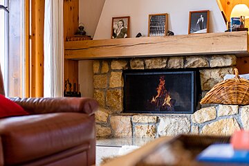 A fireplace with a wicker basket in front of it