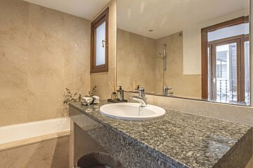 A bathroom with a sink and a large mirror